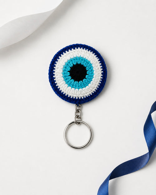 Handmade blue crochet evil eye keychain by Kreatknit